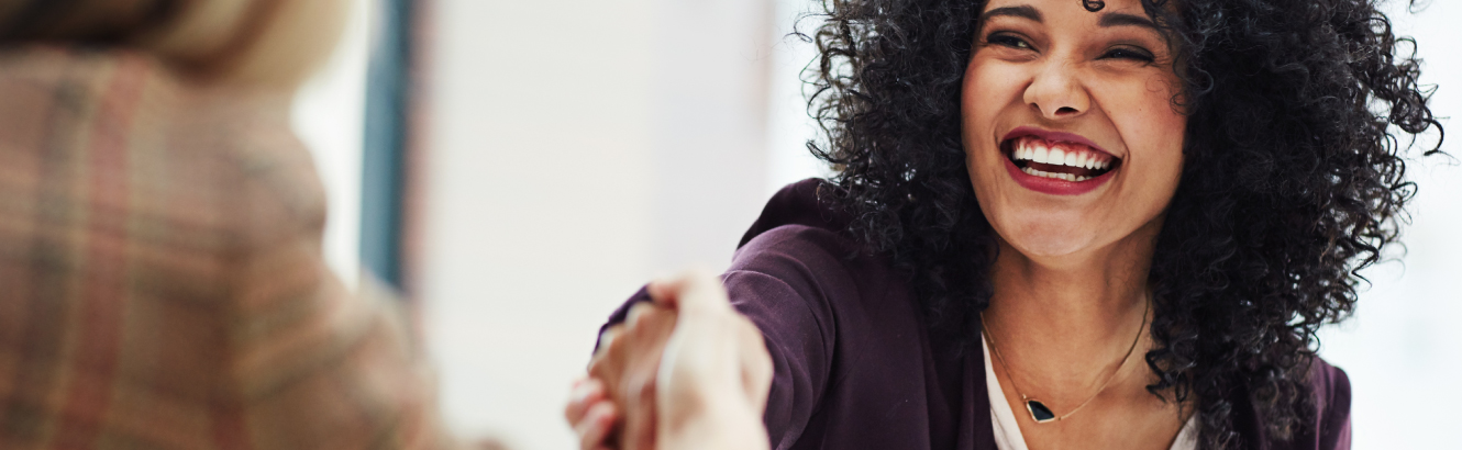 Two women shaking hands