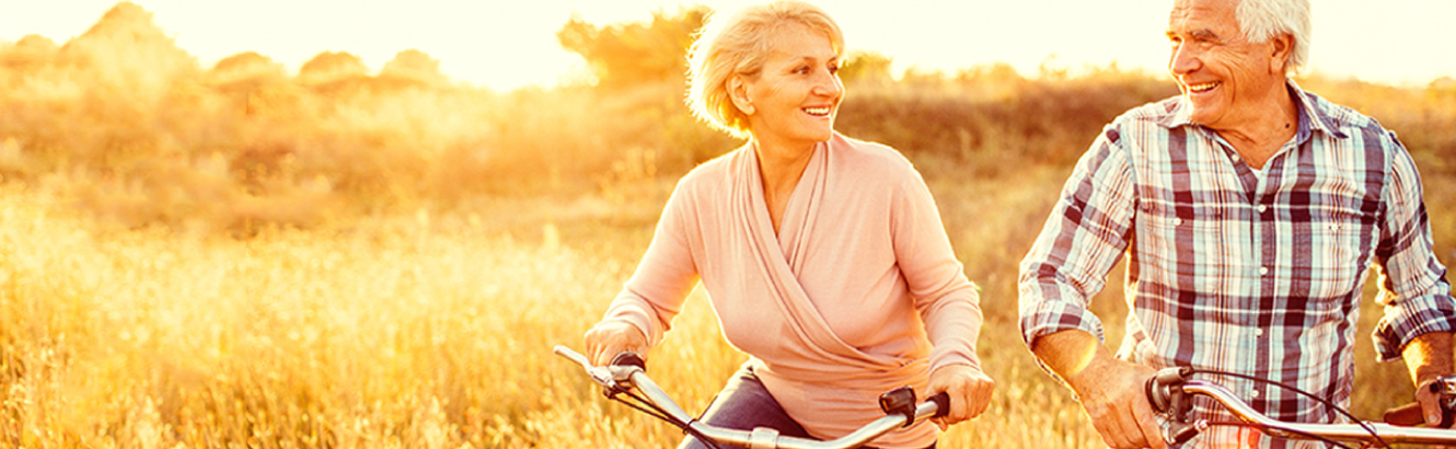 A mature couple riding bikes